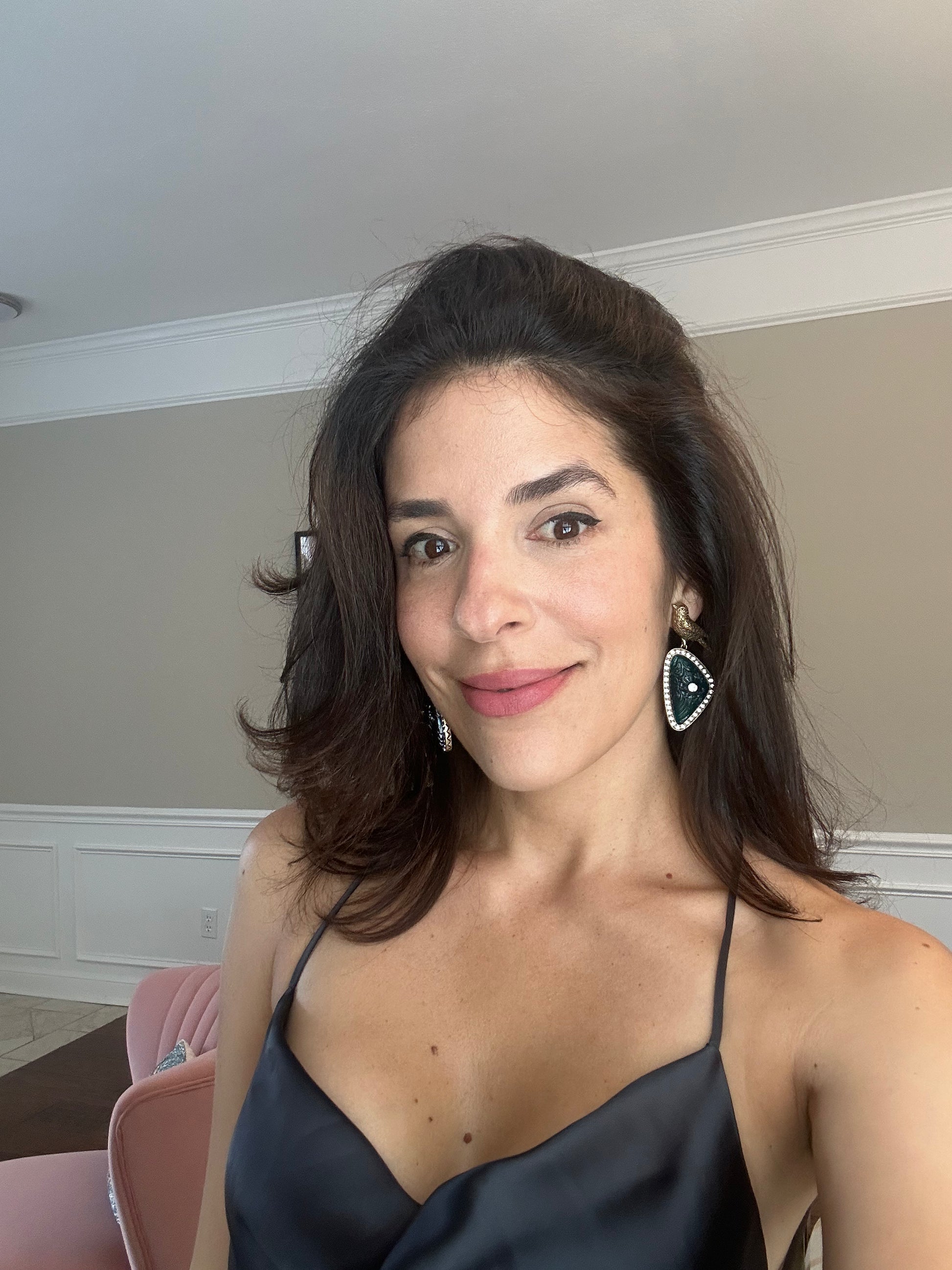 Woman wearing a black top with a neutral background