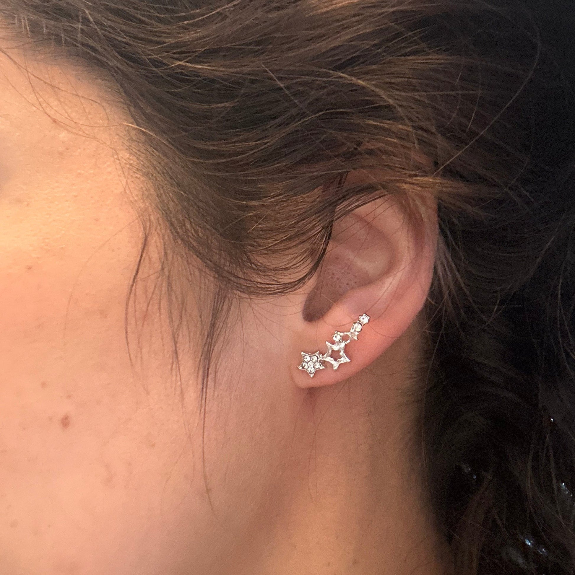 Close-up of an ear with a star-shaped earring
