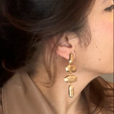 Woman adjusting her hair with a neutral background
