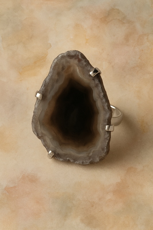 Geode ring with silver accents on a beige background