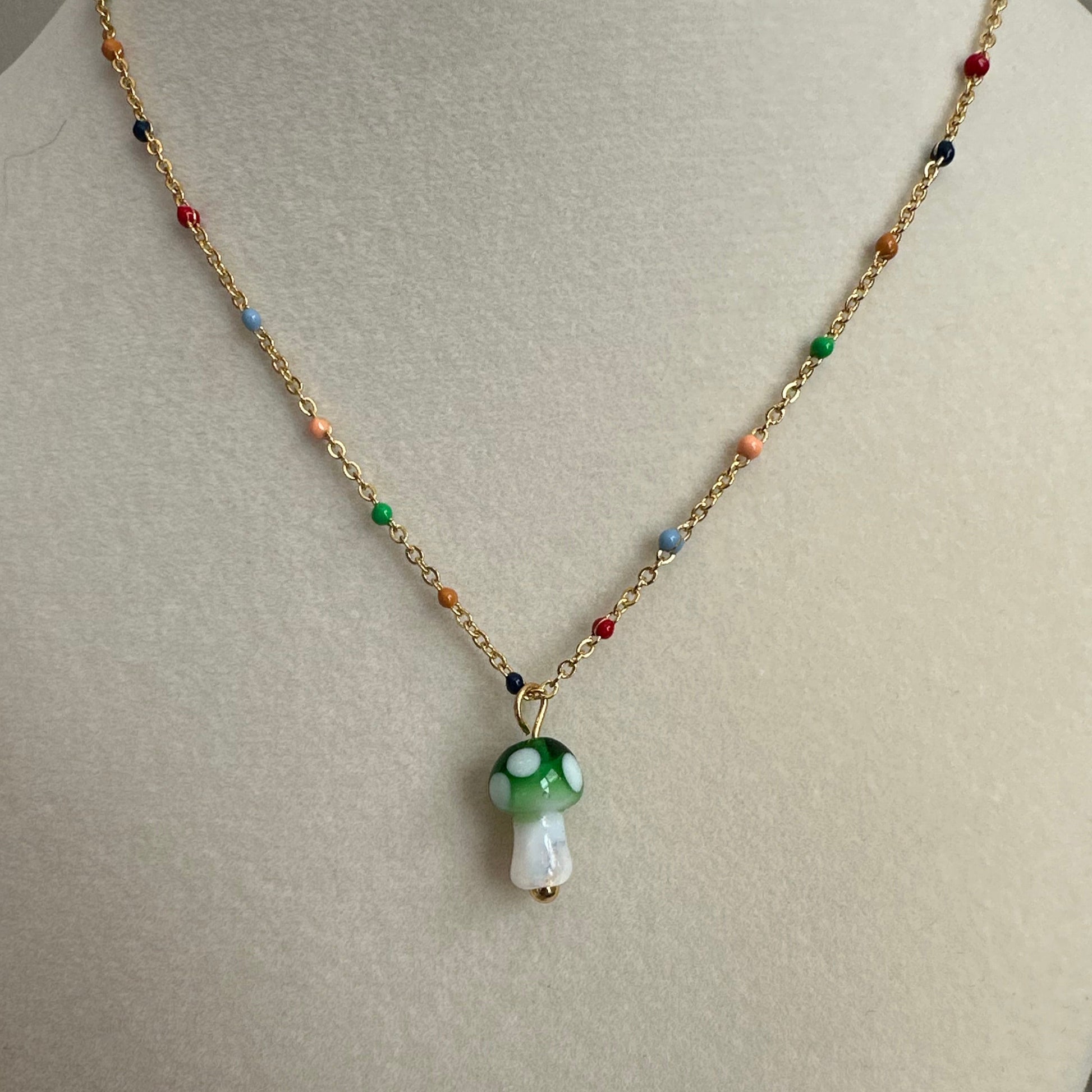 Necklace with a colorful pendant on a mannequin bust.