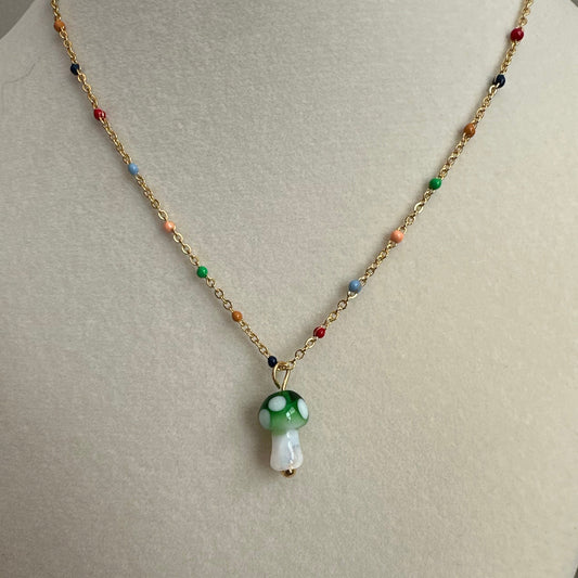 Necklace with a colorful pendant on a mannequin bust.
