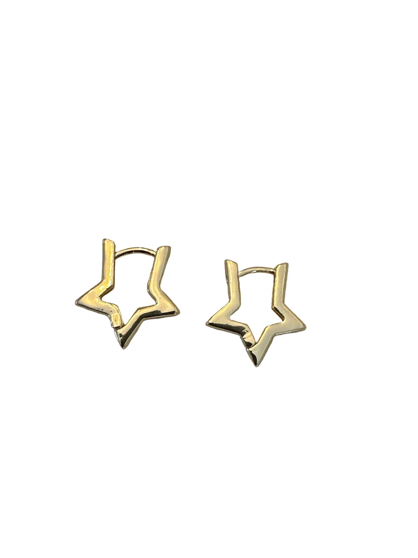 Gold star-shaped earrings on a light fabric surface