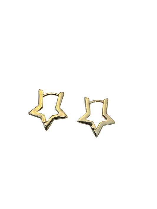 Gold star-shaped earrings on a light fabric surface