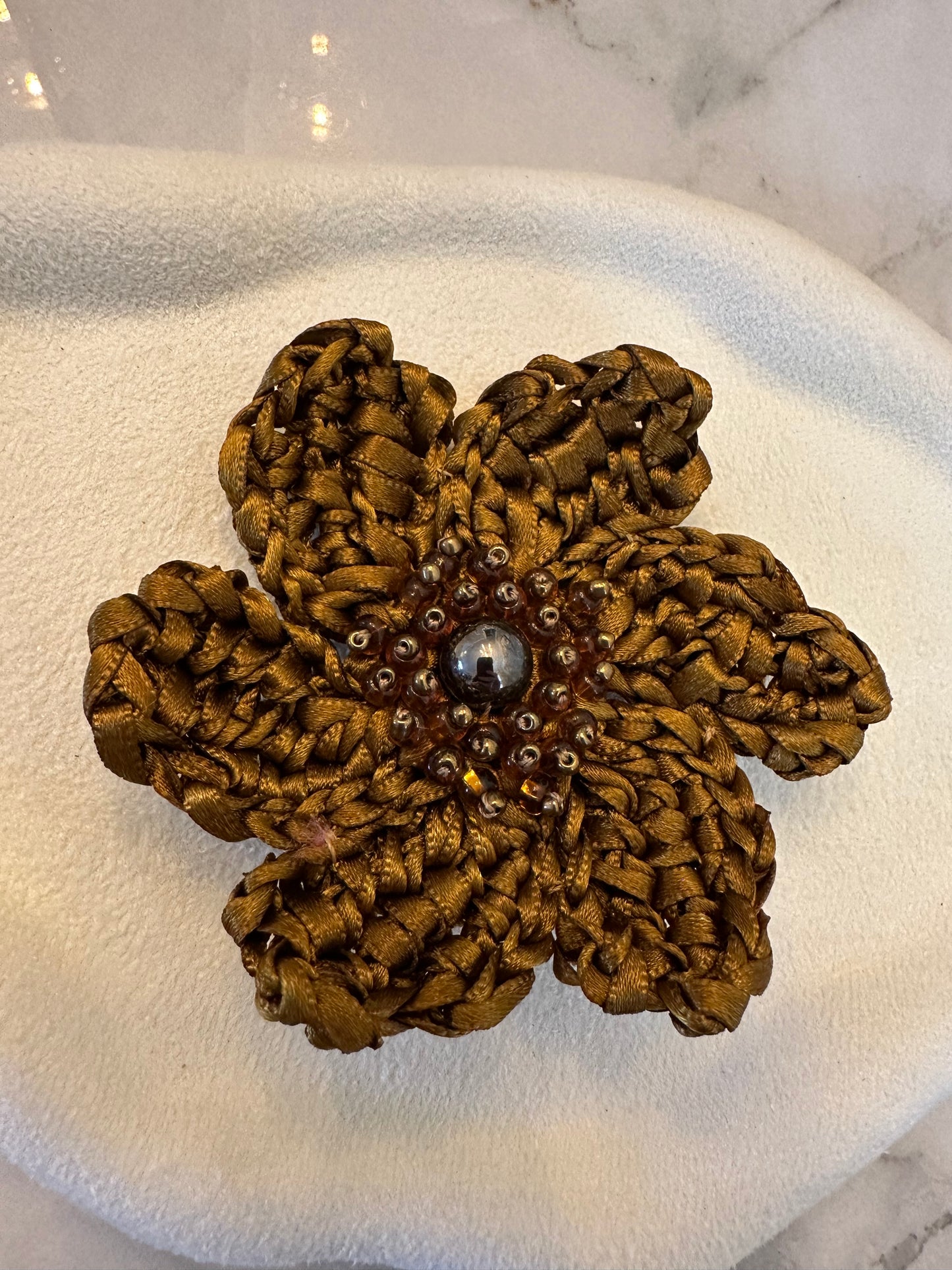 Brown textured flower-shaped object on a white surface