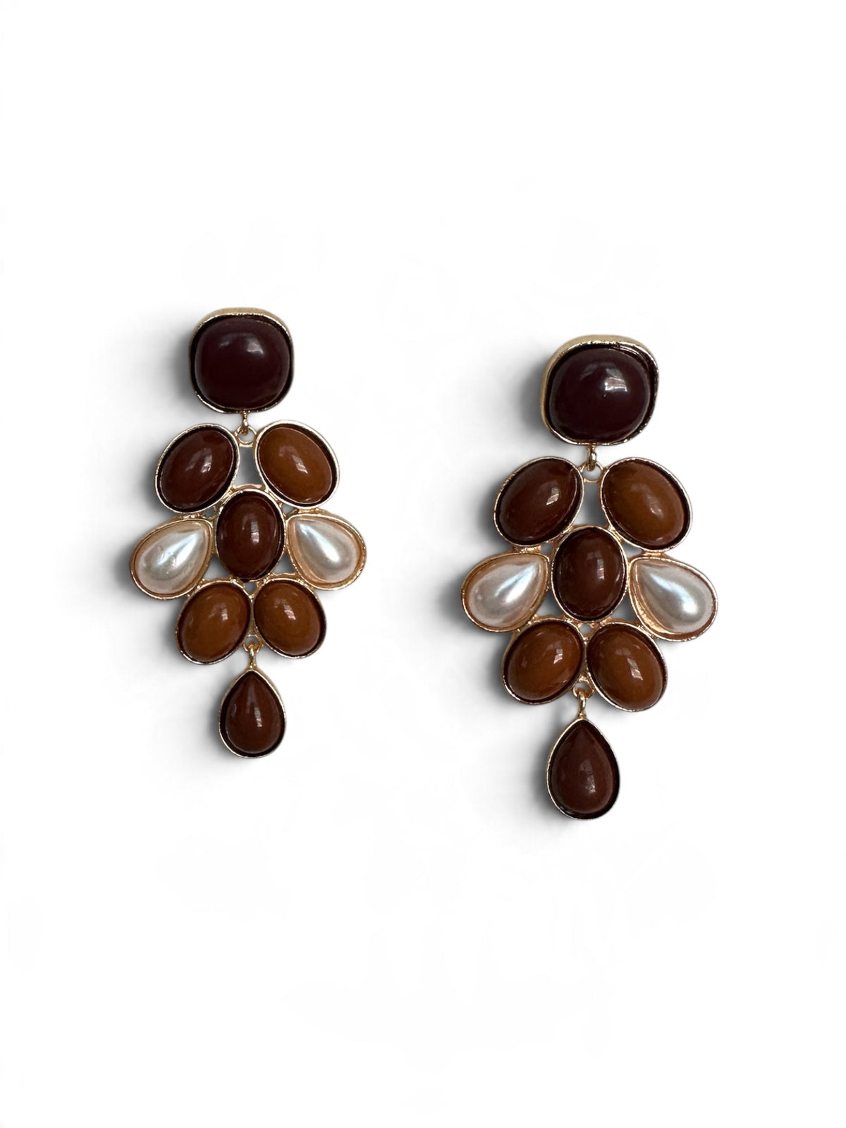 A pair of gold-tone statement dangle earrings featuring dark brown and medium brown cabochon stones, oval brown stones, and white faux-pearl accents, displayed on a clean white background.